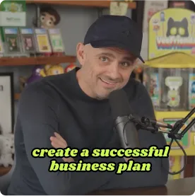 Man wearing a black cap and shirt smiling in front of a microphone with text overlay: create a successful business plan.
